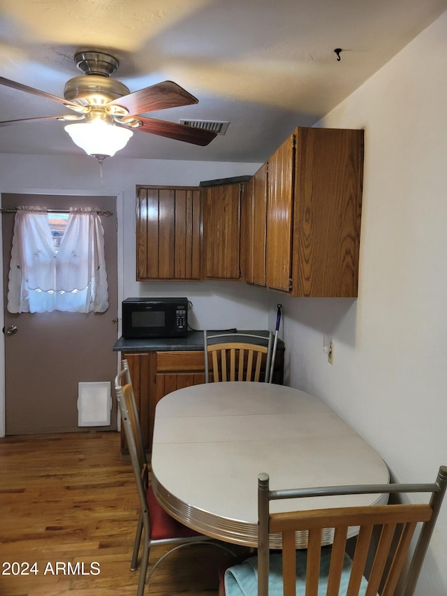 kitchen with wood-type flooring and ceiling fan