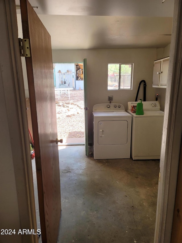 washroom featuring cabinets and separate washer and dryer