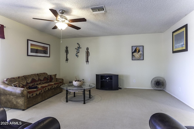 carpeted living room featuring baseboards, visible vents, a textured ceiling, and a ceiling fan