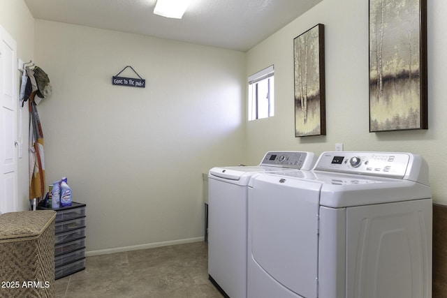 clothes washing area with laundry area, baseboards, and washer and clothes dryer