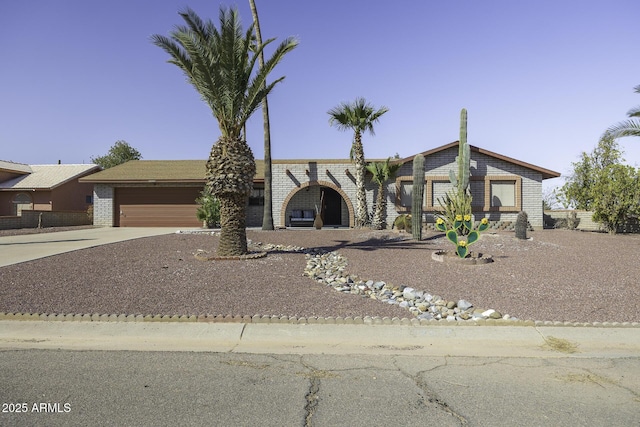 view of front of house with concrete driveway and a garage