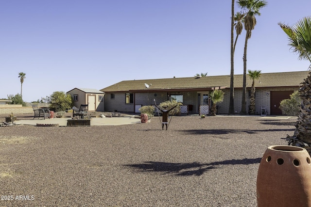 view of front of property with an outbuilding and a storage shed