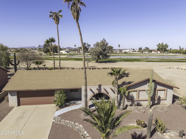 view of yard with a garage and concrete driveway