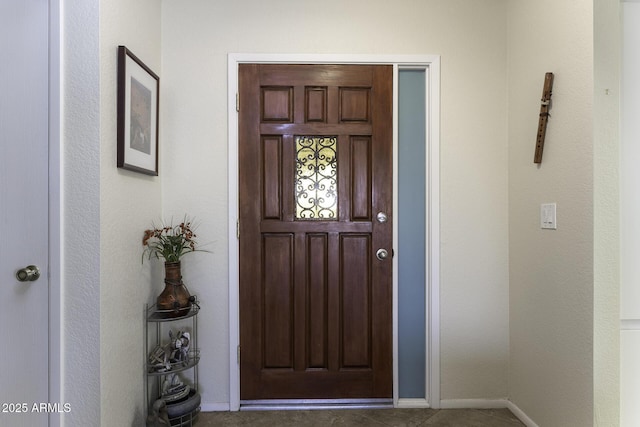 foyer featuring baseboards