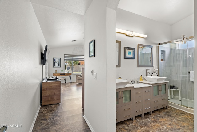 bathroom with a sink, double vanity, a stall shower, visible vents, and lofted ceiling