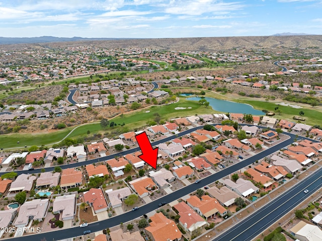 aerial view featuring a water and mountain view, a residential view, and view of golf course