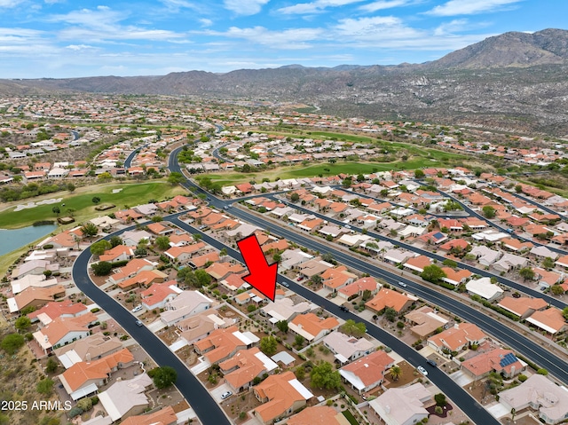 aerial view with a water and mountain view, a residential view, and golf course view