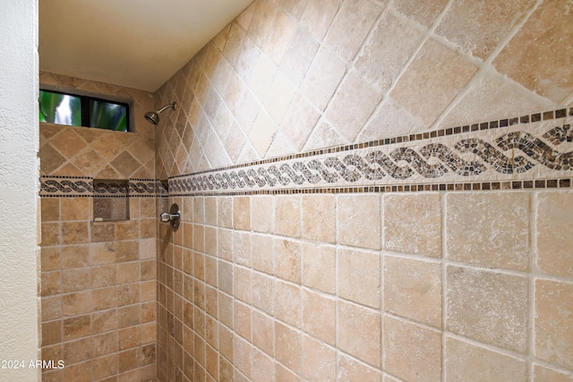 bathroom with tiled shower