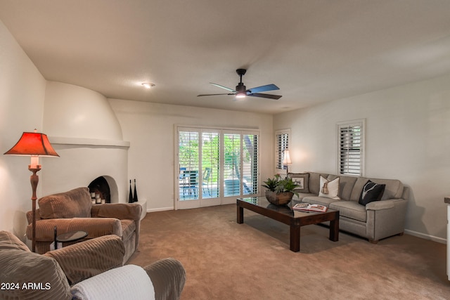 carpeted living room with ceiling fan