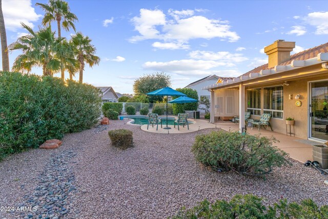 view of yard featuring a fenced in pool and a patio