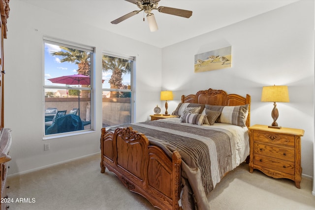 bedroom with ceiling fan and light colored carpet