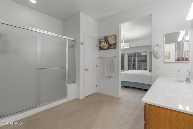 bathroom with vanity and a shower with shower door