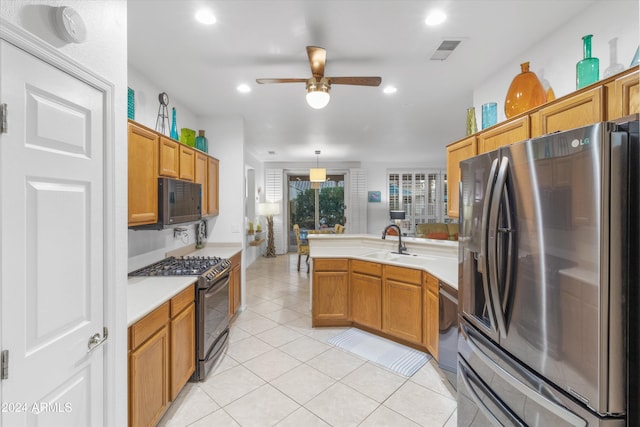 kitchen with ceiling fan, sink, hanging light fixtures, light tile patterned flooring, and appliances with stainless steel finishes