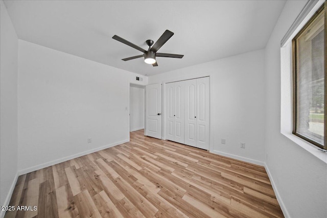 724 N Pine St, Gilbert, AZ 85233 - unfurnished bedroom with light wood finished floors, baseboards, a closet, and ceiling fan