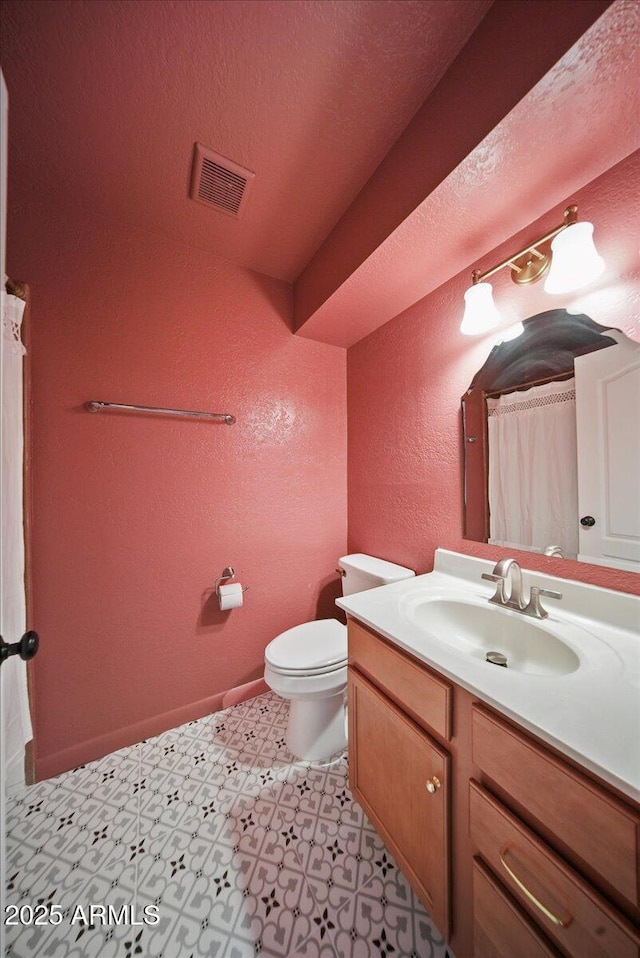 724 N Pine St, Gilbert, AZ 85233 - bathroom with a textured wall, vanity, toilet, and tile patterned floors