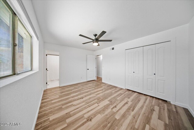 724 N Pine St, Gilbert, AZ 85233 - unfurnished bedroom with light wood-style floors, baseboards, a closet, and a ceiling fan