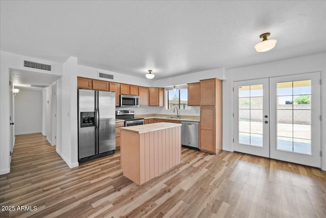 724 N Pine St, Gilbert, AZ 85233 - kitchen featuring appliances with stainless steel finishes, a sink, light wood finished floors, and french doors