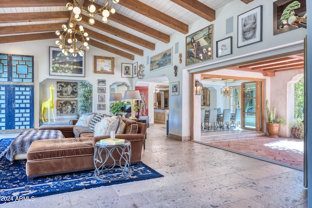 living room with an inviting chandelier, stone tile floors, wood ceiling, and beam ceiling