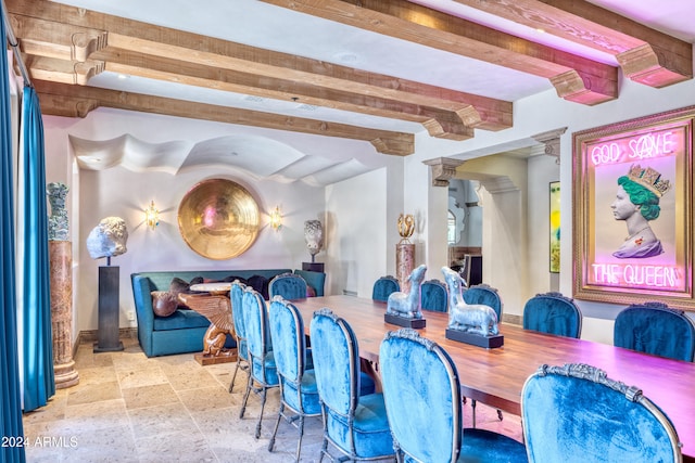 dining area featuring beam ceiling and stone tile floors