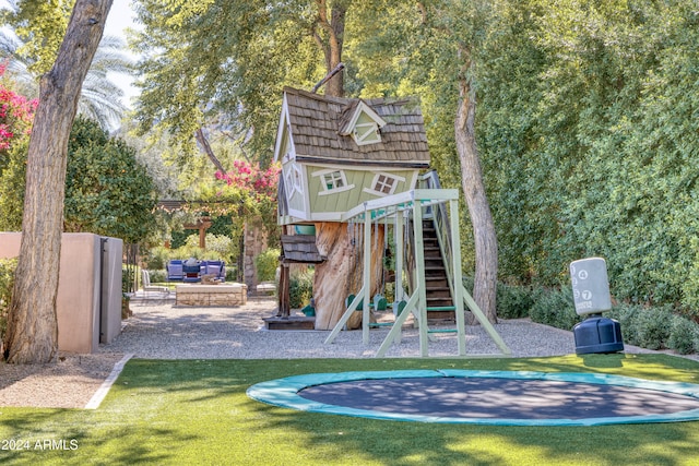 community jungle gym with a lawn, a patio, and a trampoline