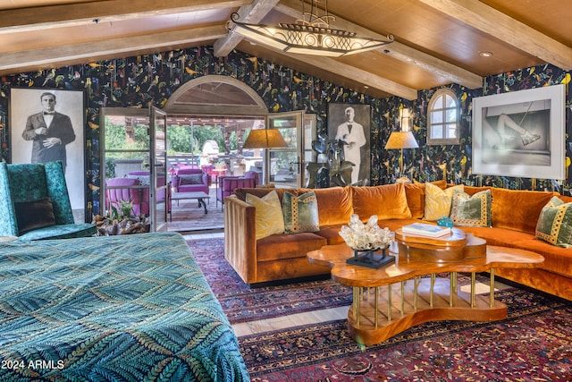 living room with wood finished floors, vaulted ceiling with beams, and wallpapered walls