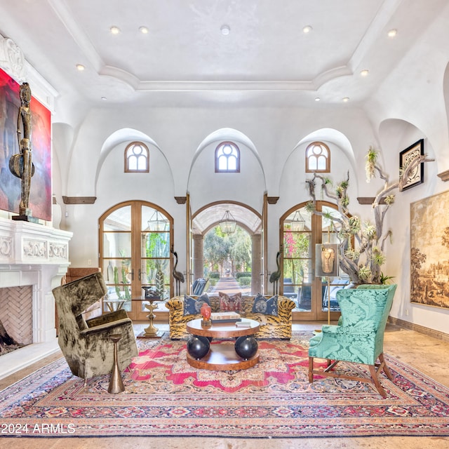 living room featuring recessed lighting, french doors, a raised ceiling, and a high ceiling