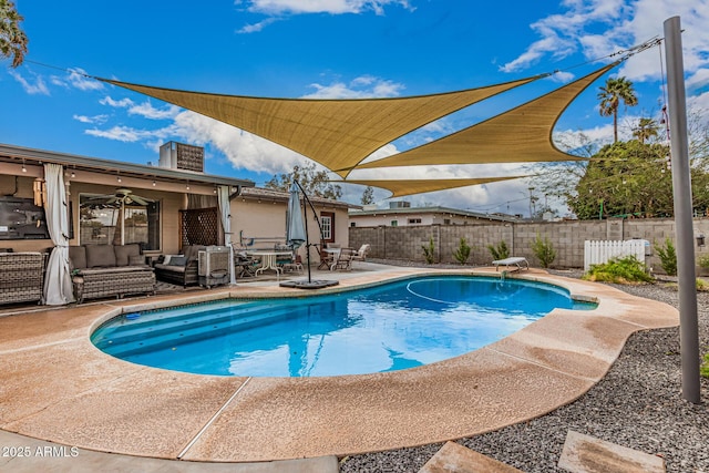 view of swimming pool featuring a patio, a ceiling fan, a fenced backyard, a diving board, and an outdoor hangout area