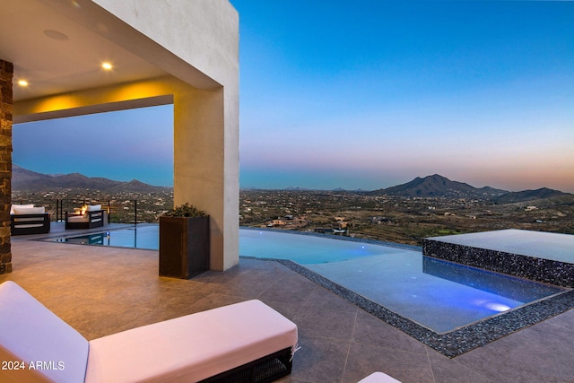 pool at dusk with a mountain view