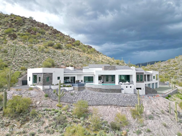 back of property with a mountain view