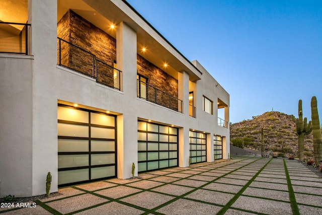 property exterior at dusk featuring a mountain view