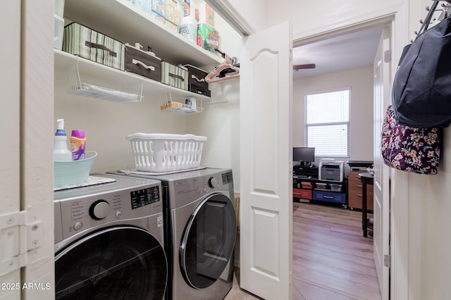 laundry room with washer and dryer, laundry area, and light wood-style flooring