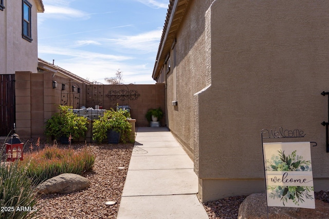 view of home's exterior featuring fence and stucco siding