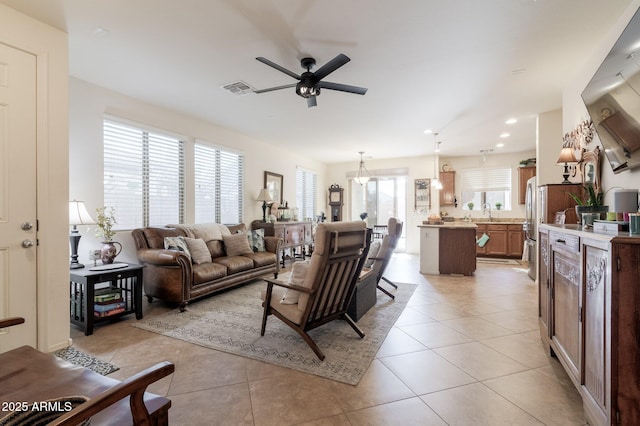 living room featuring light tile patterned floors, ceiling fan, visible vents, and recessed lighting