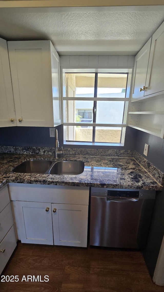 11026 N 28th Dr Unit 34, Phoenix, AZ 85029 - kitchen featuring dishwasher, a sink, white cabinetry, a textured ceiling, and dark stone countertops