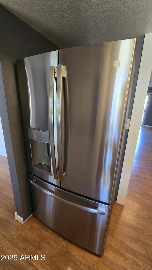 11026 N 28th Dr Unit 34, Phoenix, AZ 85029 - kitchen view of stainless steel fridge with ice dispenser, wood finished floors, and a textured ceiling
