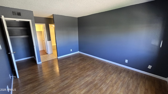 11026 N 28th Dr Unit 34, Phoenix, AZ 85029 - unfurnished bedroom featuring wood finished floors, baseboards, and a textured ceiling