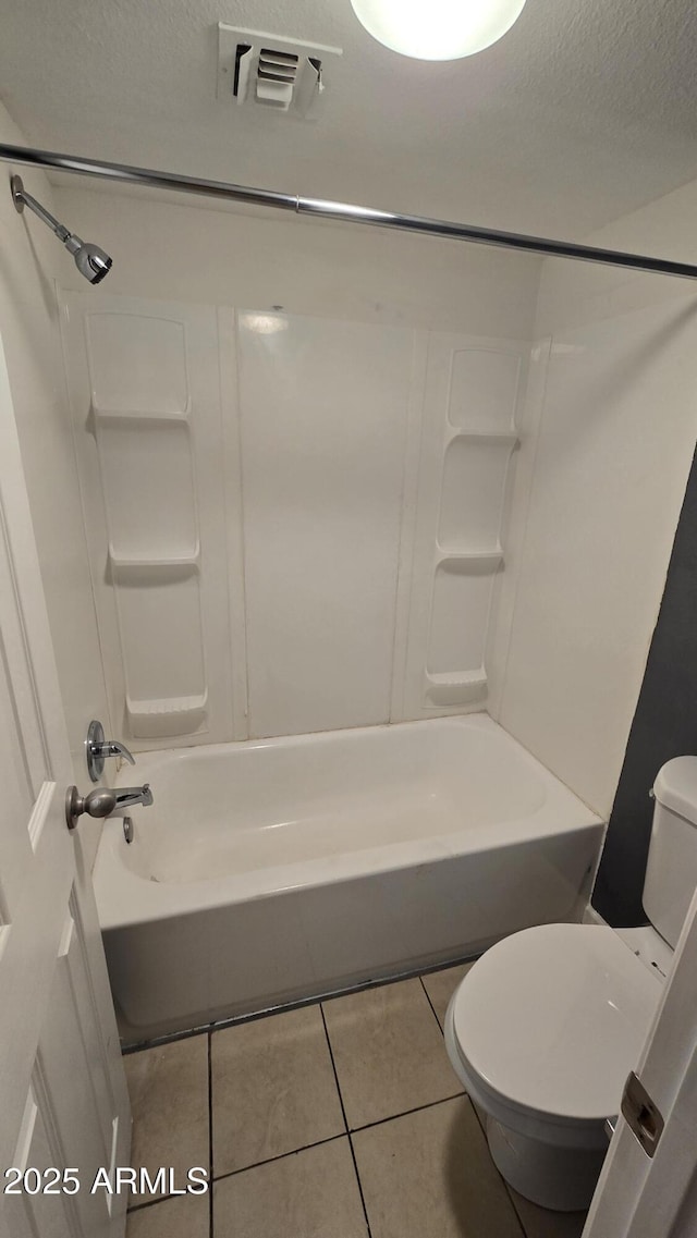 11026 N 28th Dr Unit 34, Phoenix, AZ 85029 - bathroom featuring toilet, tile patterned flooring, shower / washtub combination, and a textured ceiling