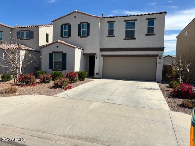 7227 N 125th Dr, Glendale, AZ 85307 - mediterranean / spanish-style home featuring a tile roof, stucco siding, an attached garage, and concrete driveway