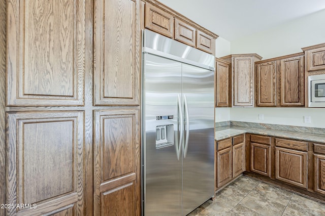 30374 N 124th Dr, Peoria, AZ 85383 - kitchen featuring built in appliances, brown cabinets, and light stone counters