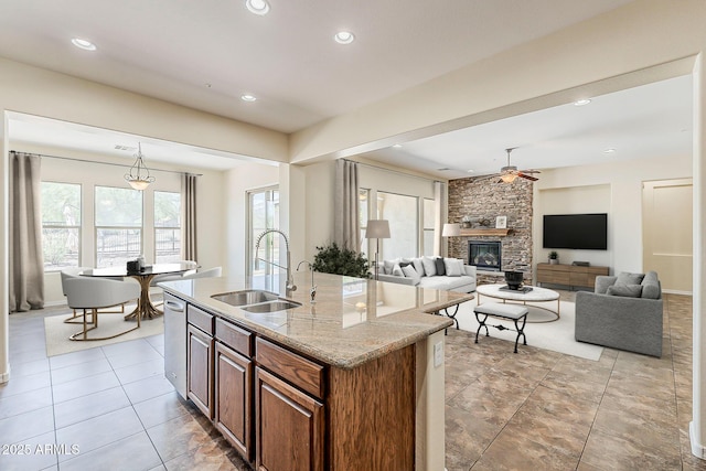 30374 N 124th Dr, Peoria, AZ 85383 - kitchen with a sink, a stone fireplace, recessed lighting, ceiling fan, and an island with sink