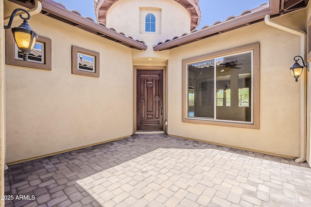 30374 N 124th Dr, Peoria, AZ 85383 - view of exterior entry with a patio and stucco siding