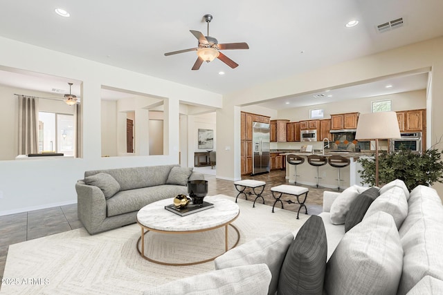 30374 N 124th Dr, Peoria, AZ 85383 - living room with ceiling fan, recessed lighting, baseboards, and healthy amount of natural light