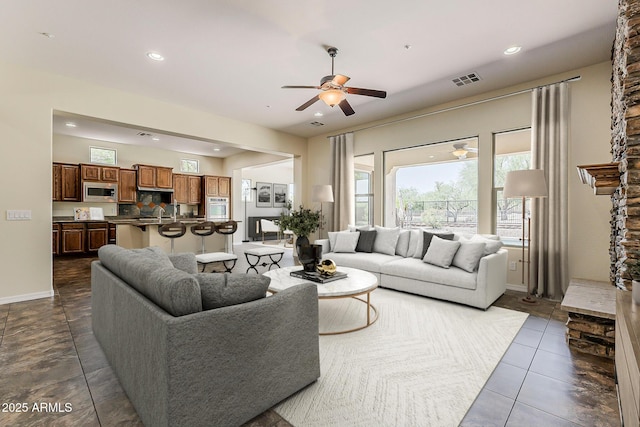 30374 N 124th Dr, Peoria, AZ 85383 - living room with a ceiling fan, baseboards, recessed lighting, and dark tile patterned flooring