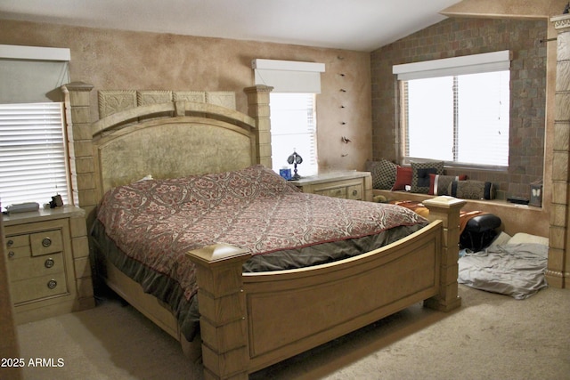 bedroom with lofted ceiling and light carpet