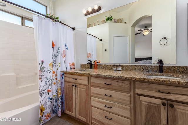 bathroom with shower / bath combo with shower curtain, ceiling fan, and vanity