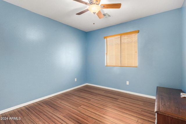 spare room featuring hardwood / wood-style flooring and ceiling fan