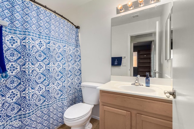 bathroom featuring toilet and vanity