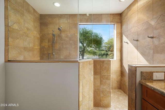 bathroom with vanity and tiled shower