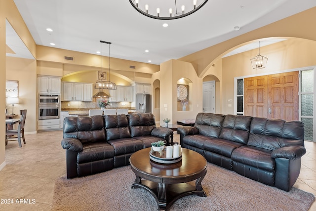 tiled living room featuring an inviting chandelier