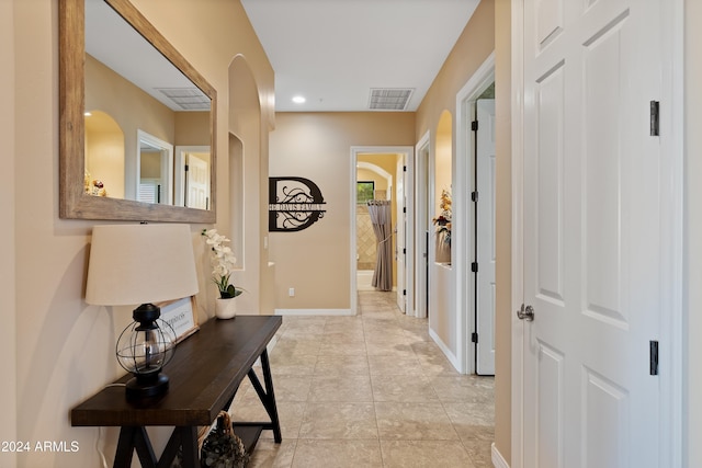 corridor featuring light tile patterned flooring